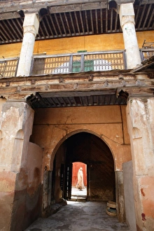 Africa Travel Destination Drucke: View out from courtyard with figure walking by