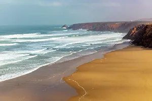 North African Coastline Drucke: Waves breaking coastal cliffs and sandy beach