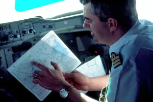 Aircraft Navigation Systems Drucke: Pilot looking at map