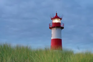 North Sea Coastline Images Drucke: List-Ost lighthouse against cloudy sky at twilight