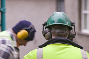 Construction Worker Safety Gear Drucke: Workmen using ear protectors