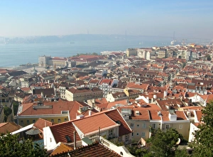 European Cityscapes At Sunset Drucke: View across city rooftops from castle towards river