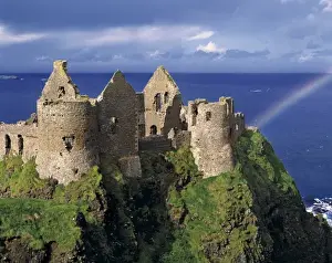Historic Sites In Europe Drucke: A rainbow strikes medieval Dunluce Castle on the Antrim Coast in Co