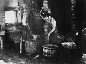 19th Century Occupations Drucke: BLACKSMITH AT WORK. A blacksmith and assistant at work. Undated photograph
