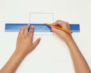 Studio Shot Of Hands Drucke: Hands using pencil and ruler to create geometric drawing, view from above