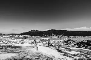 Australian Mountain Landscapes Drucke: Fence and gate around a small snowy mountain