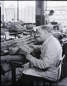 Construction Machinery Images Drucke: Adding Machine Factory Worker Seated