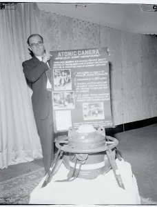 Oil Industry Equipment Drucke: A.L. Dowling Posing Next to Atomic Camera