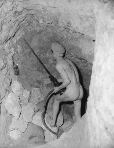 Historic Mining Equipment Drucke: A Miner Using a Drill
