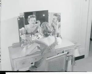 Classic Female Portraits Drucke: Model Making up Her Face at Vanity Table