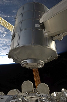 International Space Station Drucke: The Permanent Multipurpose Module in the grasp of Canadarm2
