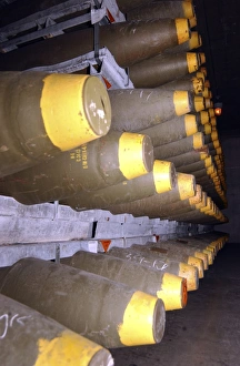 Military Ammunition Drucke: Racks of bombs sit inside the interior of a warehouse
