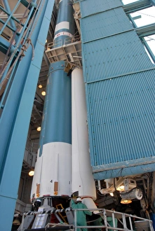 Aerospace Photography Drucke: The second solid rocket motor is moved into place alongside the Delta II first stage