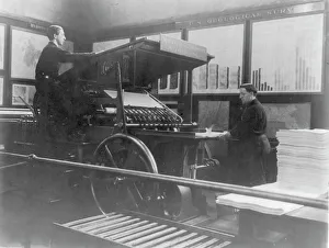 Vintage Printing Equipment Drucke: 2 men operating map printing press at U