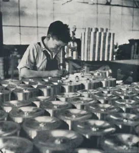 Air Transport Industry Drucke: Apprentice with microscope (testing the hardness of pistons), 1941. Artist: Cecil Beaton