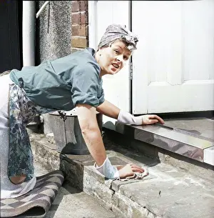 Colorised Black And White Print Drucke: Charlady scrubbing steps, c1955. Creator: Arthur Charles Kirby Ware
