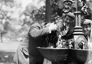 Black And White NYC Street Scene Drucke: Cooling his head - N.Y. on hot day, between c1910 and c1915. Creator: Bain News Service