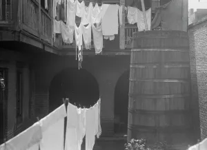 Black And White Architecture Images Drucke: Courtyard with cistern and hanging laundry