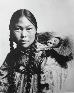 Alaska Photography Drucke: Eskimo mother with child on back, c1906. Creator: Lomen Brothers