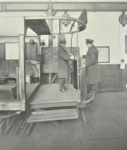 Black And White Transport Photos Drucke: Learner-driver under instruction in a mock-up of tram car cab, London, 1932