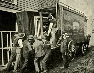 Historic Transportation Methods Drucke: Loading The Camera On A Van For Removal, 1901. Creator: Unknown