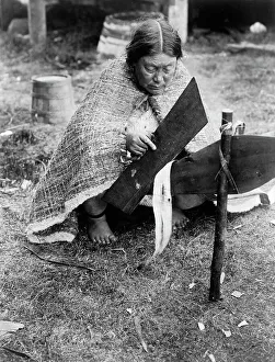 Native American Woman Drucke: Preparing cedar bark-Nakoaktok, c1914. Creator: Edward Sheriff Curtis