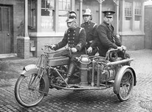 Vintage Firefighting Equipment Drucke: A Rex motorcycle being used by firemen