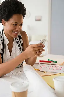 Schwarze Unternehmerin verwendet Handy.