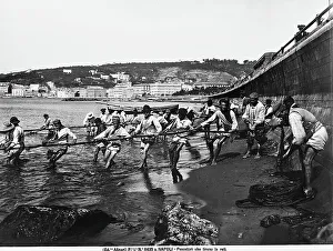 Seaside Landscape Photography Drucke: Fishermen pulling in their nets on a Neapolitan beach