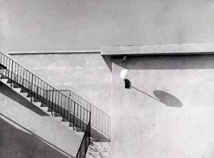 Building Facade Design Drucke: Geometry'. Side part of a building with shadows projected on the wall
