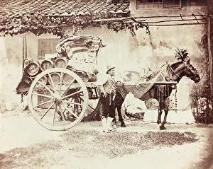 Horse Drawn Wagon Drucke: A man posing next to a wagon wine