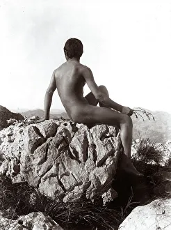 Young Man On Rock Drucke: Young man posing on a rock