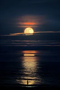 Vollmond steigt über dem Meer auf