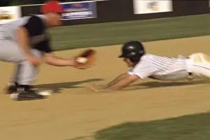 Young Baseball Player Drucke: Baseball player sliding into a base