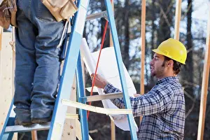 Home Construction Process Drucke: Carpenter explaining house plans