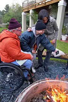 Diverse Group Of Young Adults Drucke: Friends around fire pit