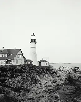 Low Angle View Of A Building Drucke: Low angle view of a lighthouse on the coast