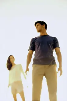 Caucasian Young Adults Drucke: Low angle view of a young couple standing