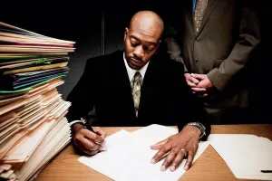 Male Office Worker Drucke: Man doing paperwork with man behind him