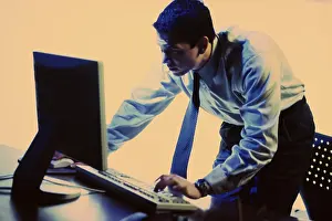 Side profile of a businessman using a computer