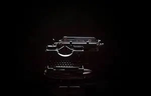 Black Background Photography Drucke: Typewriter on table against black background