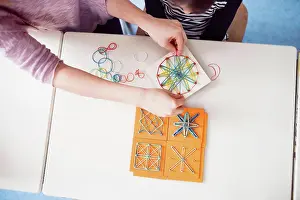 Classroom Learning Tools Drucke: Top view of teacher using geoboard in class