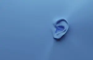 Communication Concept Image Drucke: 3d rendering of an ear on a blue background with space for your text or image