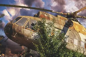 Deserted European Landscape Photos Drucke: Abandoned, rusty helicopter surrounded by trees
