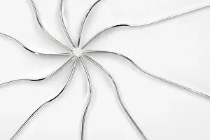 Isolated Studio Photography Drucke: Abstract silver lines form a symmetrical pattern on a white background
