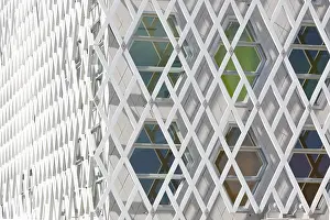 Abstract Architectural Style Drucke: Abstract view of a auditorium facade showcasing geometric patterns of interlocking diamond shapes and hexagonal windows