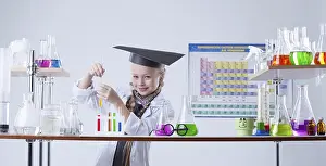Child In Lab Coat Drucke: Adorable little chemist posing in lab with flasks