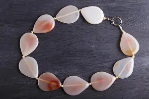 Close Up View Of Agate Drucke: Agate colored beads on a black background