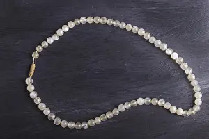 Precious Stone Embellishments Drucke: Agate colored beads on a black background