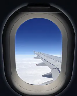 Airplane Window View Drucke: Airplane window, wing of the plane and clouds